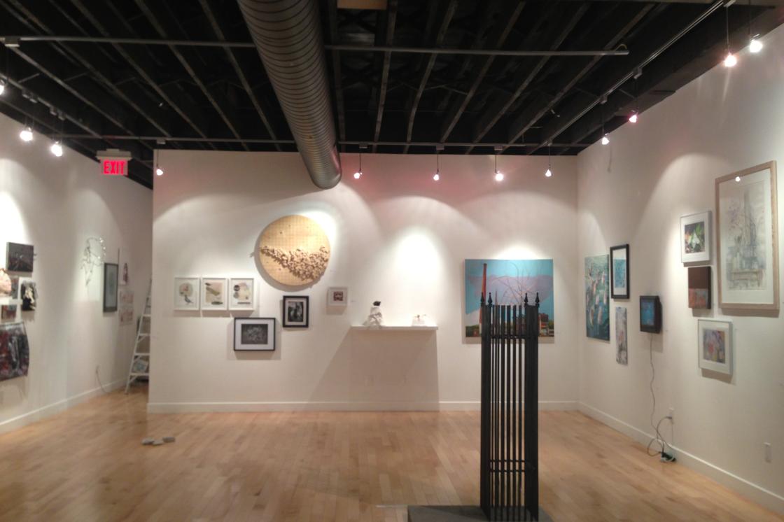 Wide shot of the gallery featuring a varity of artwork.