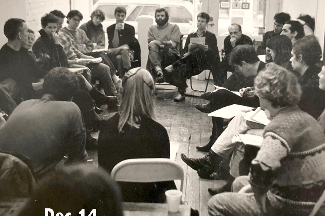 image of a group of people sitting in a circle in chairs